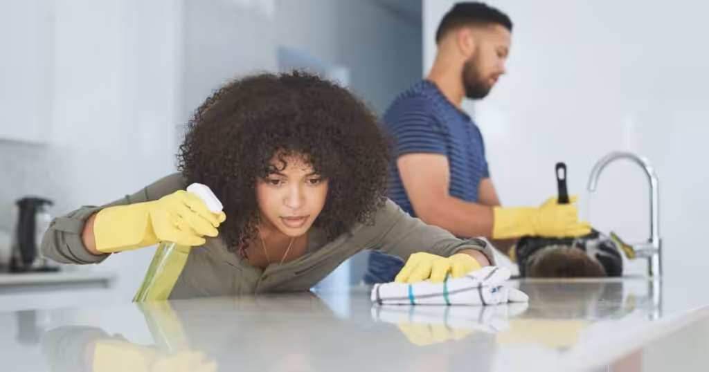 Cleaner wiping counter and paying attention to the details